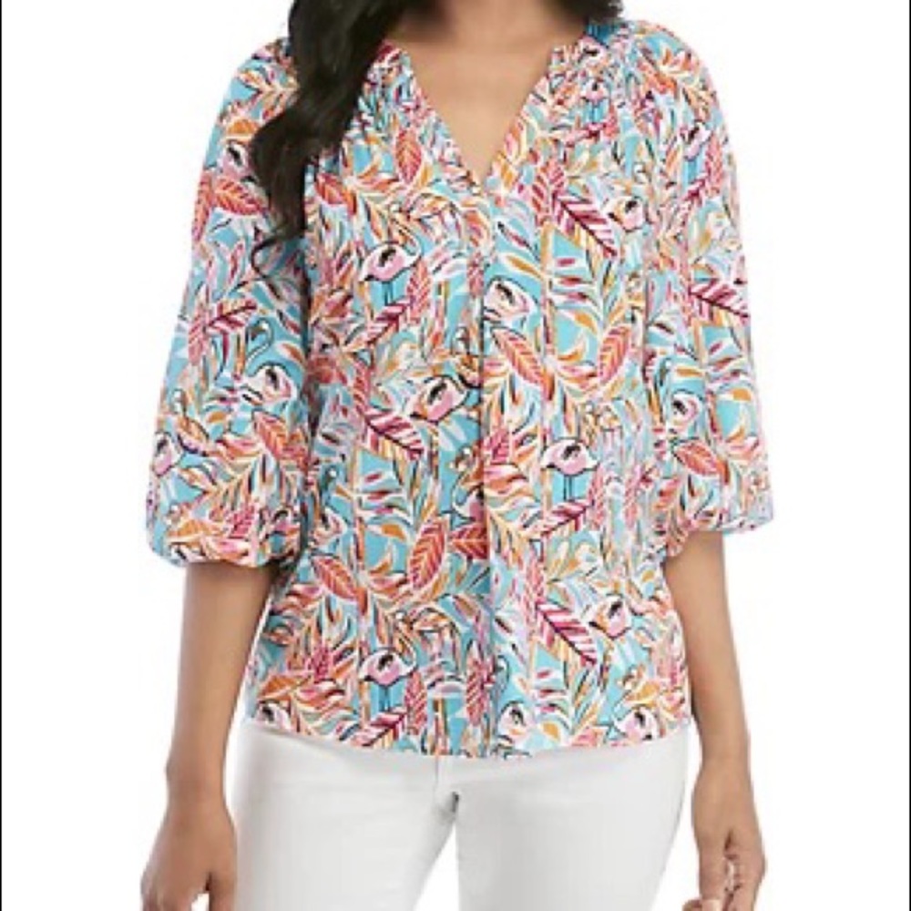A flamingo pattern adds colorful, preppy style to this 3/4 sleeve peasant top…